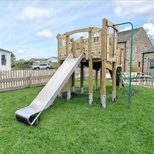 play tower and slide with fireman pole in pub garden