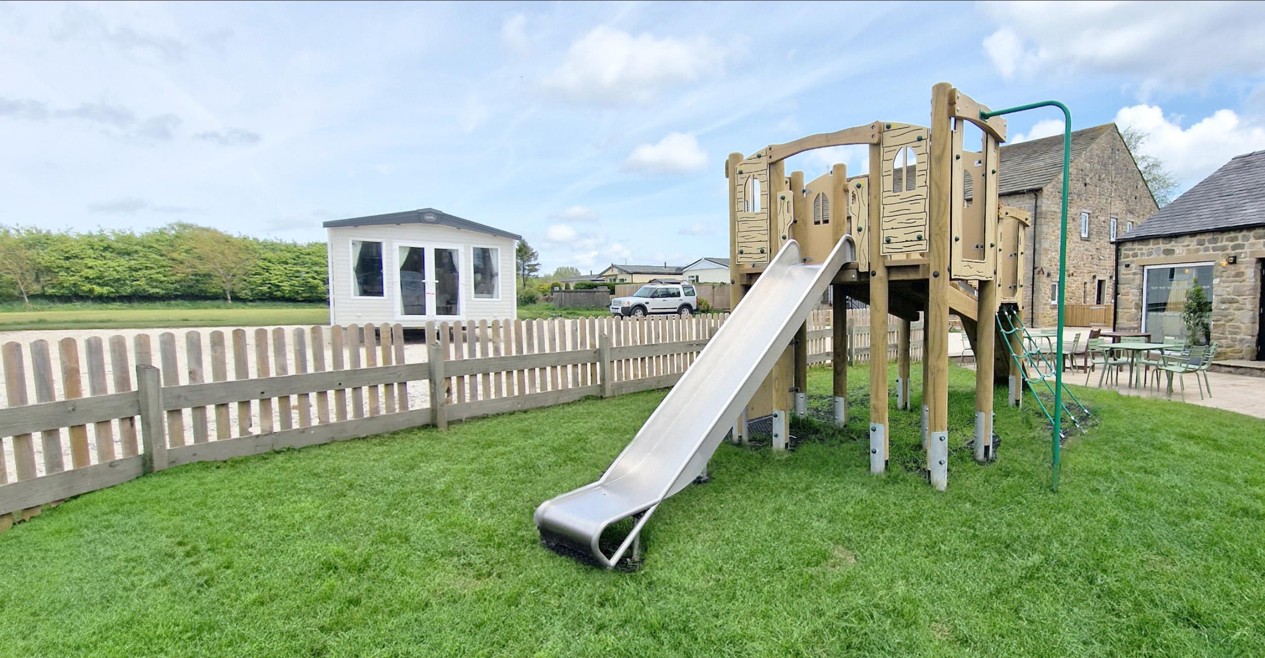 large playground scheme for primary school with climbing frame, artificial grass, outdoor classroom and trim trails