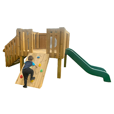 child climbing up climbing wall of play tower with slide
