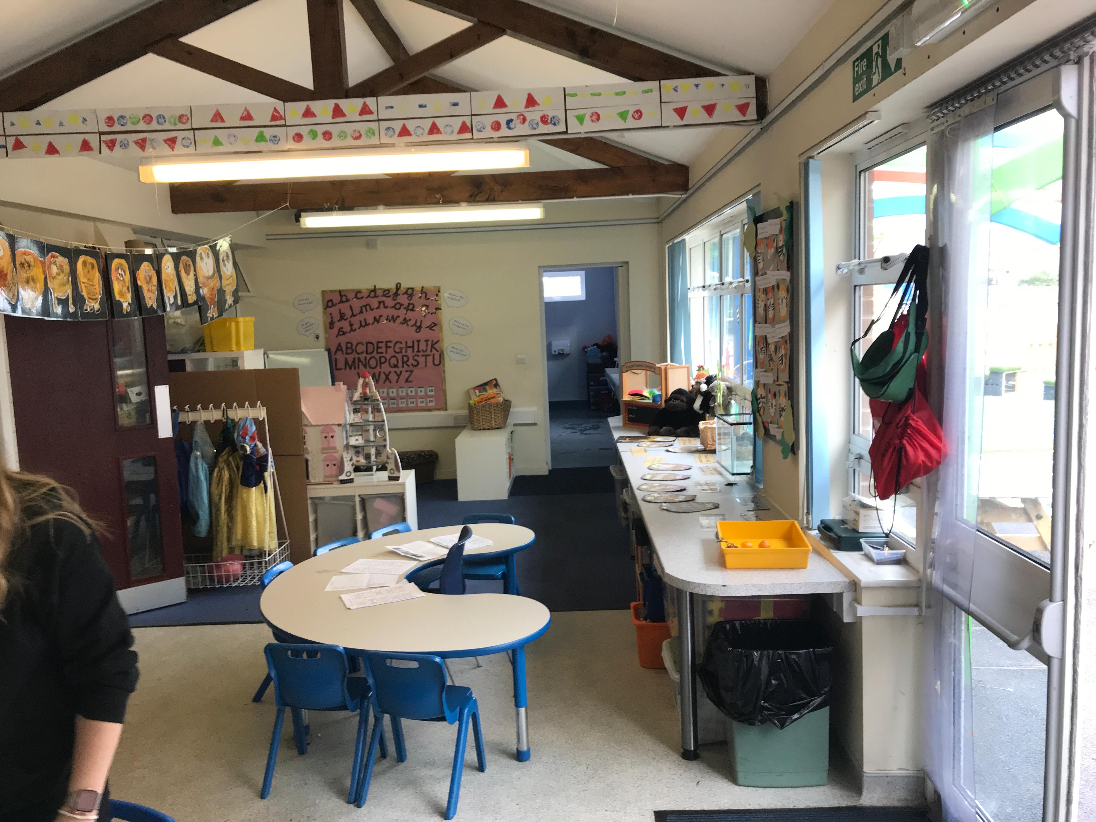 primary school classroom area with old furniture and plastic seating