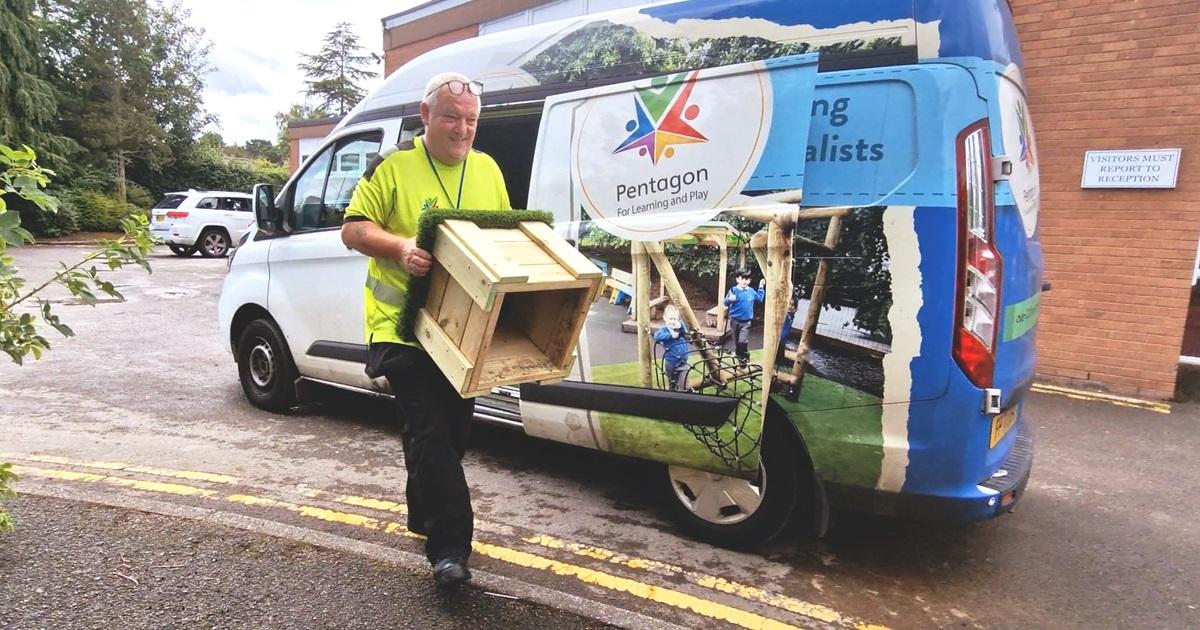 delivery driver unloading play equipment from van