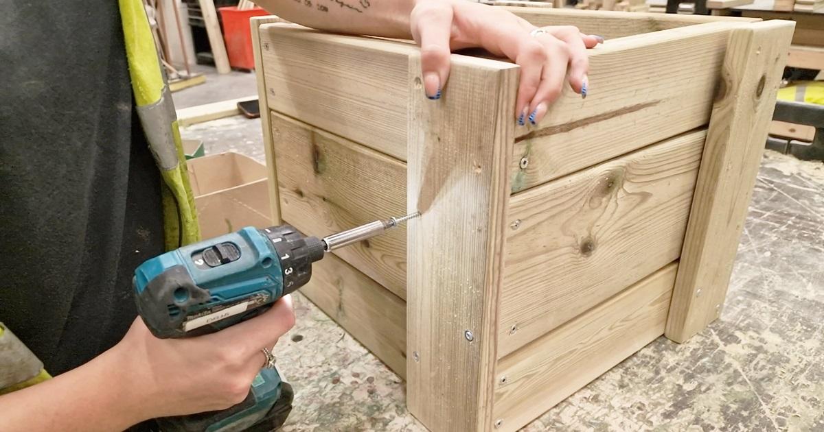 carpenter screwing wood together to build a block for the Get Set, Go! Blocks range