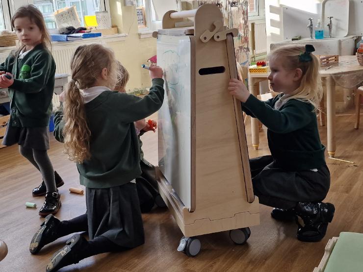 School children drawing on art easel of Stack and Sit Package 3 product