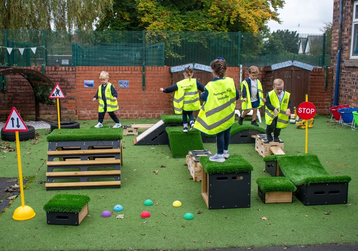 nursery children walking along a Play Builder set with a Get Set, Go! Blocks set positioned as a custom trim trail