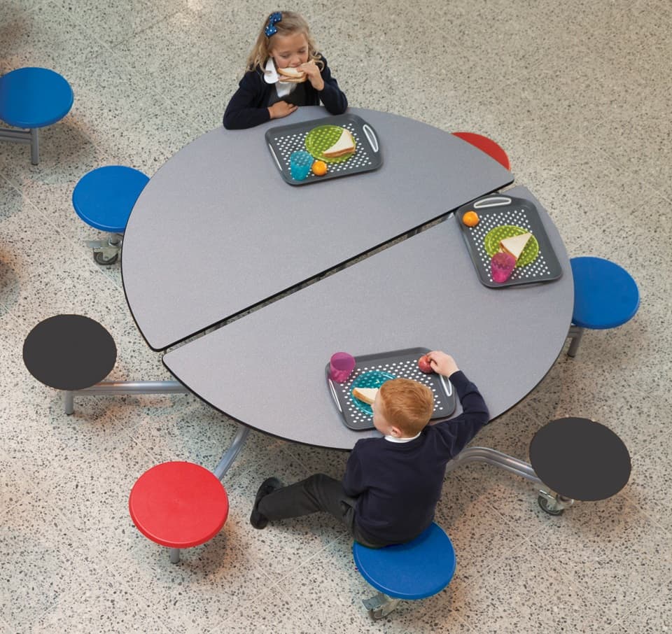 two school students sitting at a SpaceRight school dining table in a canteen having their lunch