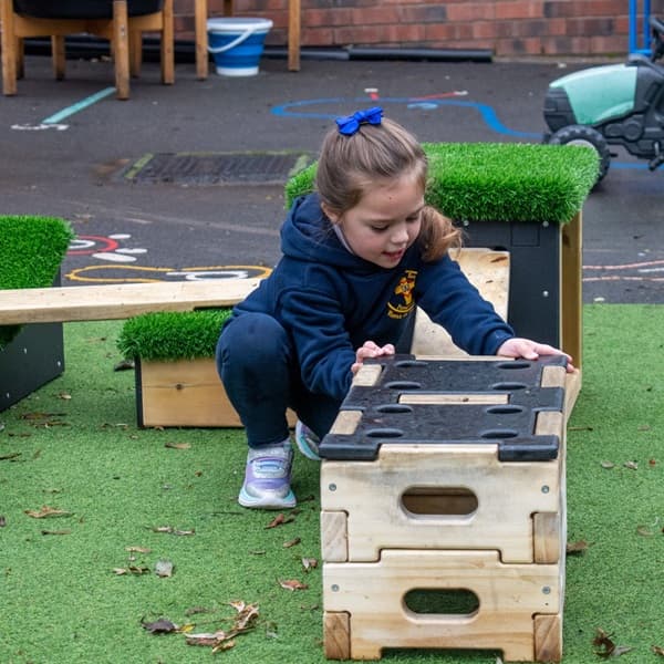 school children climbing on Get Set, Go! Blocks in school playground