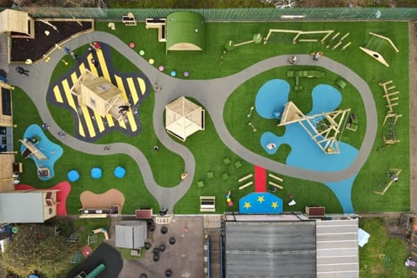 An aerial view of Waltham Holy Cross Primary School's playground with a variety of play equipment and surfacing
